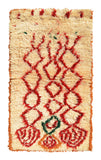 Overhead view of a deeply plush, funky handmade 1970s vintage Azilal Moroccan wool and cotton area rug named Life in Motion (3'8" x 6') featuring a cream base covered in a wild, squiggly red geometric diamond pattern that morphs into abstract circular shapes at the bottom, accented with touches of green and orange, with a 3/4-inch pile.
