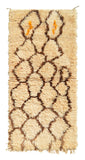 Overhead view of a deeply plush, highly textured handmade 1980s vintage Beni Ourain Moroccan wool and cotton accent rug named Basic Goodness (2'8" x 5'2") featuring a cream base covered in a wandering, organic brown geometric diamond lattice with two tiny pops of bright orange yarn at the top, and a thick 1.5-inch pile.