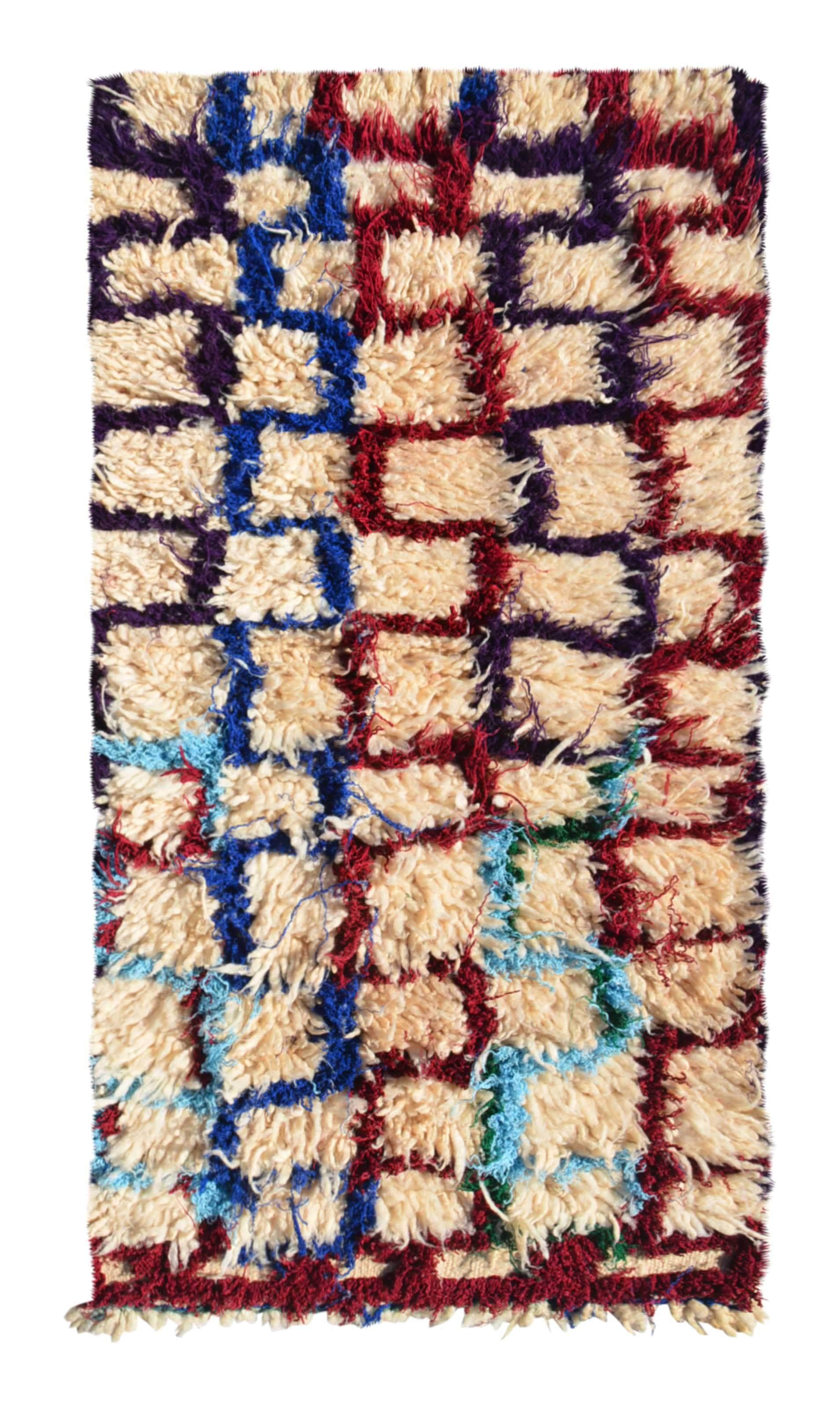 Overhead view of a deeply plush, highly textured handmade 1960s vintage Azilal Moroccan wool and cotton accent rug named Maze (2'8" x 4'8") featuring a cream base covered in a wandering, interlocking grid-like maze pattern woven in burgundy red, cobalt blue, light blue, and purple yarn, with a 1-inch pile.