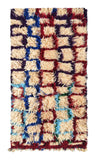 Overhead view of a deeply plush, highly textured handmade 1960s vintage Azilal Moroccan wool and cotton accent rug named Maze (2'8" x 4'8") featuring a cream base covered in a wandering, interlocking grid-like maze pattern woven in burgundy red, cobalt blue, light blue, and purple yarn, with a 1-inch pile.