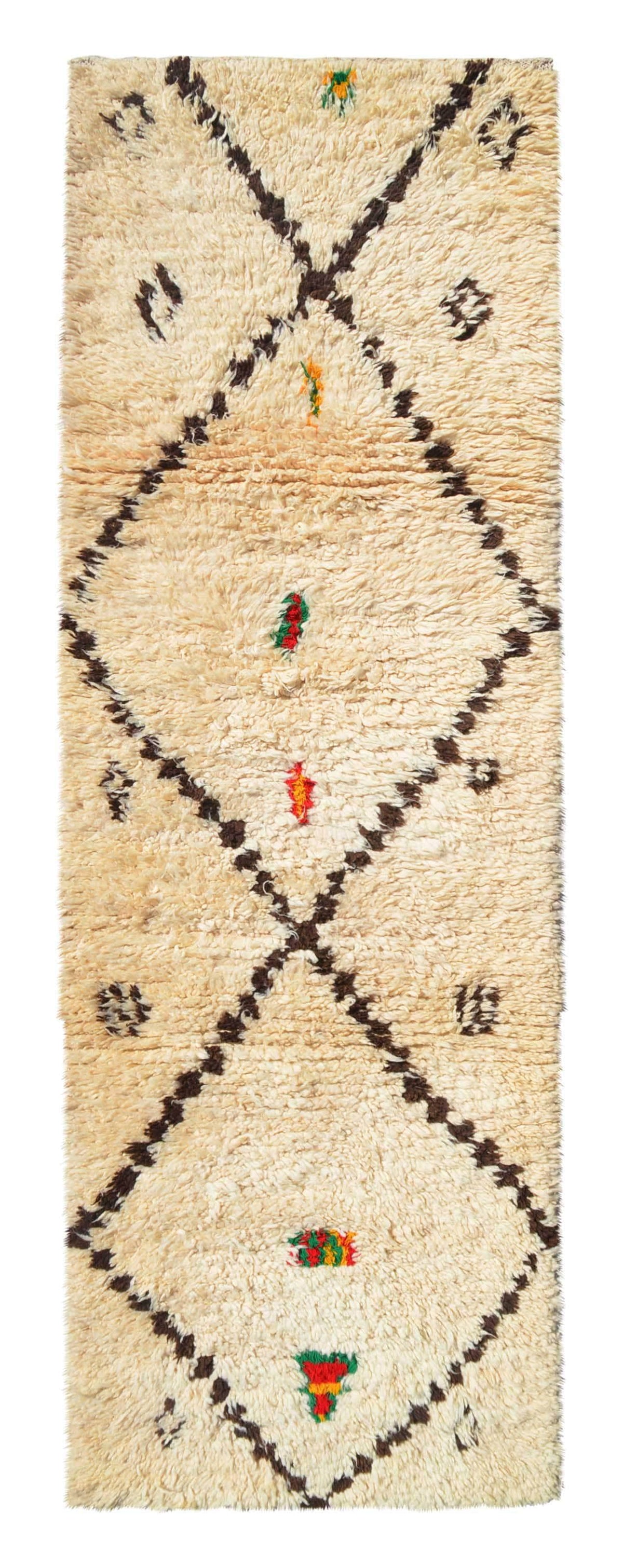 Overhead view of a deeply plush, extra-long handmade 1970s vintage Moroccan wool and cotton runner rug named Helpless (3'8" x 10'10") featuring a thick cream base covered by sweeping dark brown crisscross lines forming massive diamonds, anchored down the center axis by small stacked tribal motifs in red, green, and yellow, with a 3/4-inch pile.
