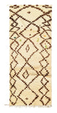 Overhead view of a deeply plush, quirky handmade 1970s vintage Beni Ourain Moroccan wool runner rug named Down Easy (3'2" x 8') featuring a thick cream base covered in an irregular, wobbly earthy brown geometric diamond lattice containing abstract symbols and tiny hidden flecks of colorful yarn, with a 1-inch pile.