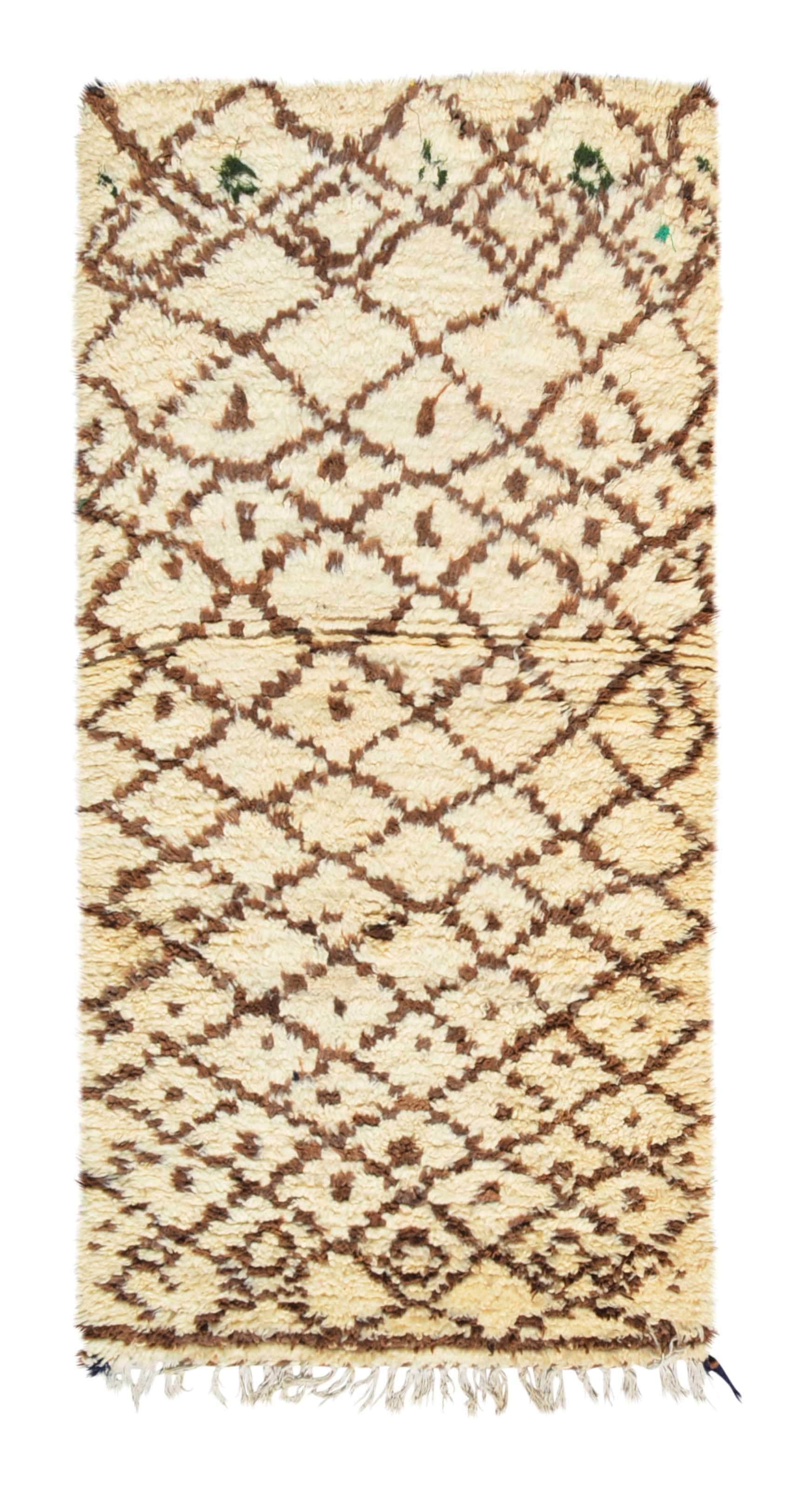 Overhead view of a very soft, deeply plush handmade 1970s vintage Beni Ourain Moroccan wool accent rug named Brown Sugar (2'9" x 5'5") featuring a cream base covered in a wavy, earthy brown geometric diamond lattice with tiny green accents near the top, and a 3/4-inch pile.