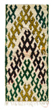 Overhead view of a beautiful, plush handmade 1960s vintage Azilal Moroccan wool and cotton accent rug named Olive Grove (2'7" x 5'10") featuring a cream base covered in an interlocking pattern of heavy, hooked geometric shapes in olive green, mustard, black, and forest green, with a 3/4-inch pile.