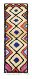 Overhead view of a deeply plush, highly vibrant handmade 1970s vintage Azilal Moroccan wool and cotton runner rug named Friday (2'6" x 8') featuring a cream base covered in a black geometric diamond lattice with solid blue centers, bordered by radiating, multi-colored concentric zig-zag lines in pink, red, teal, green, and purple, with a 3/4-inch pile.