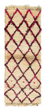 Overhead view of a very soft, deeply plush handmade 1970s vintage Beni Ourain Moroccan wool and cotton runner rug named Effortless (2'7" x 7') featuring a thick cream base covered with a classic black geometric diamond lattice intertwined with bright neon pink yarn, with a 1-inch pile.