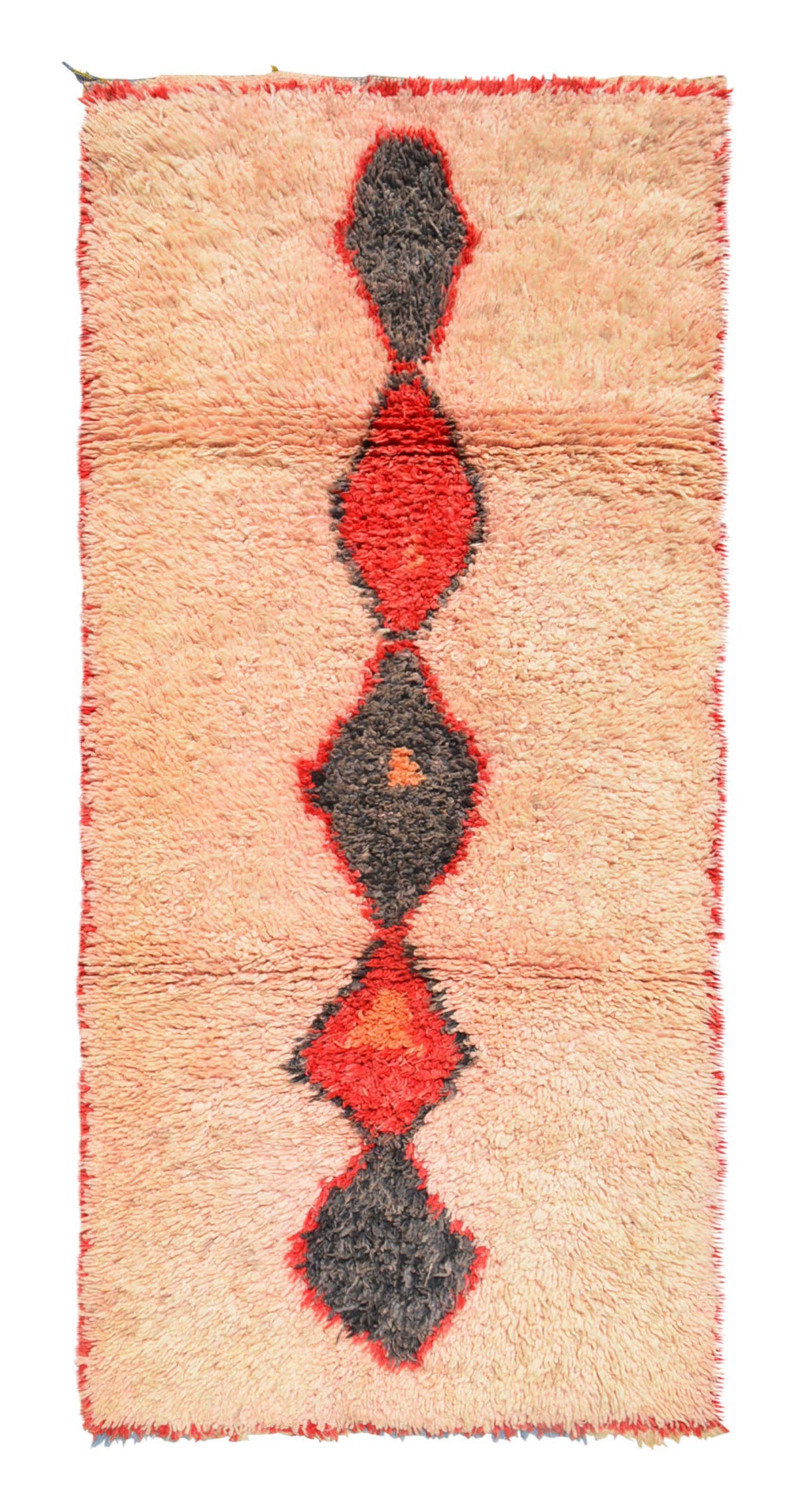 Overhead view of a fabulously soft handmade 1960s vintage Boujad Moroccan wool rug named Hopeful (3'5" x 7'5") featuring a sun-faded peach and apricot base with a central vertical column of connected geometric diamonds woven in dark charcoal and bright red, framed by red edges, with a 3/4-inch pile.