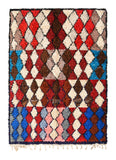 Overhead view of a vibrant, highly patterned handmade 1960s vintage Azilal Moroccan cotton area rug named Illusions (4'7" x 6'3") featuring an edge-to-edge geometric diamond lattice filled with red, blue, brown, pink, cream, and grey color blocks, with a 3/4-inch pile.