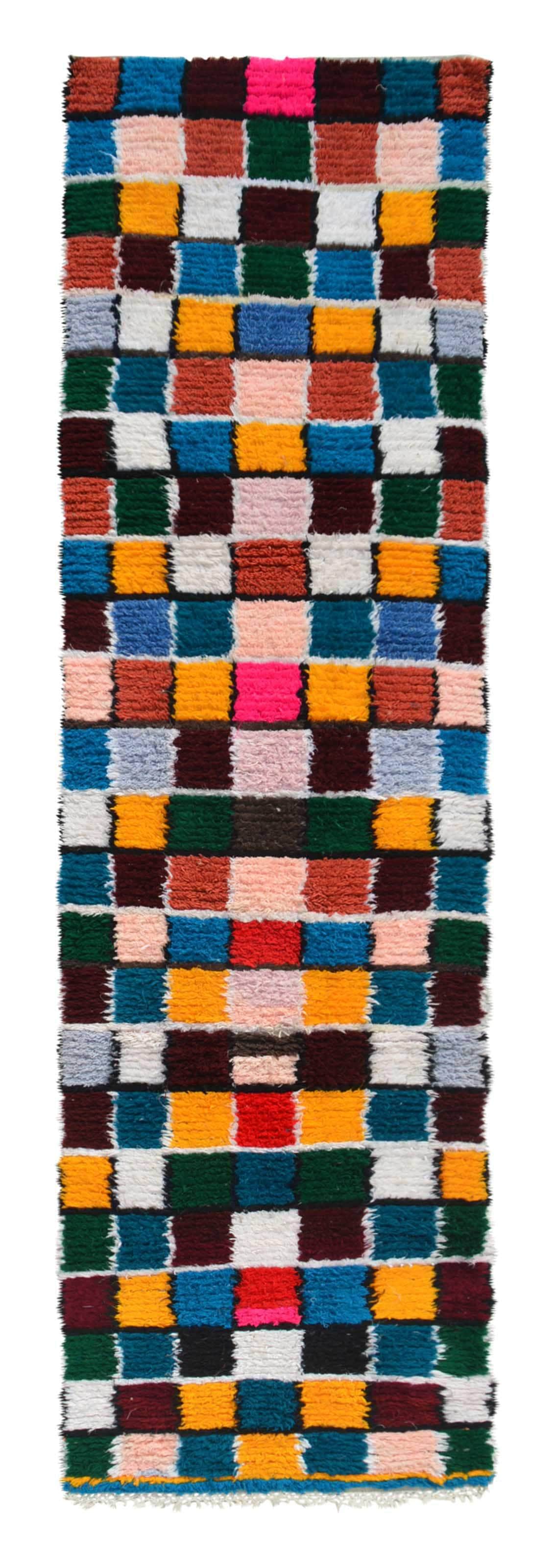 Overhead view of an extra-long, highly vibrant handmade 1970s vintage Boucherouite Moroccan cotton runner rug named Powerful (2'10" x 10'2") featuring an edge-to-edge geometric checkerboard grid woven in solid blocks of teal, green, mustard yellow, hot pink, burgundy, white, and blush, with a 3/4-inch pile.