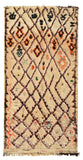 Overhead view of a massive, room-sized handmade 1960s vintage Beni Ourain Moroccan wool area rug named Highest Places (5'10" x 12'6") featuring a natural tan base covered in a brown geometric diamond lattice filled with intricate black and orange tribal symbols, bordered by a wavy peach line on the left edge, with a 3/4-inch pile.