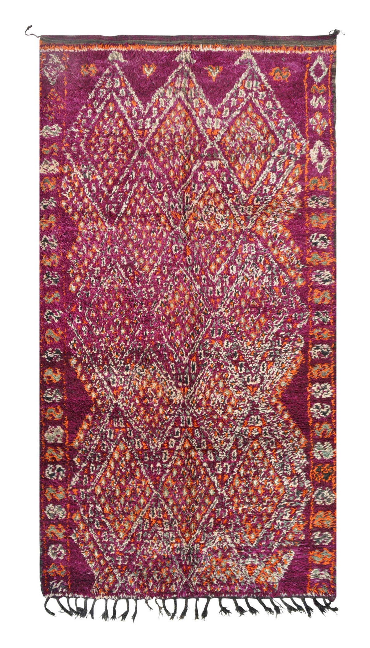 Overhead view of a deeply plush, mesmerizing handmade 1970s vintage Boujaad Moroccan wool area rug named Strawberry Fields (5'9" x 11') featuring a sprawling geometric diamond lattice woven in white, grey, and bright orange over a deep, saturated magenta background, with a 3/4-inch pile.