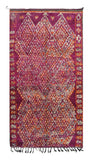 Overhead view of a deeply plush, mesmerizing handmade 1970s vintage Boujaad Moroccan wool area rug named Strawberry Fields (5'9" x 11') featuring a sprawling geometric diamond lattice woven in white, grey, and bright orange over a deep, saturated magenta background, with a 3/4-inch pile.
