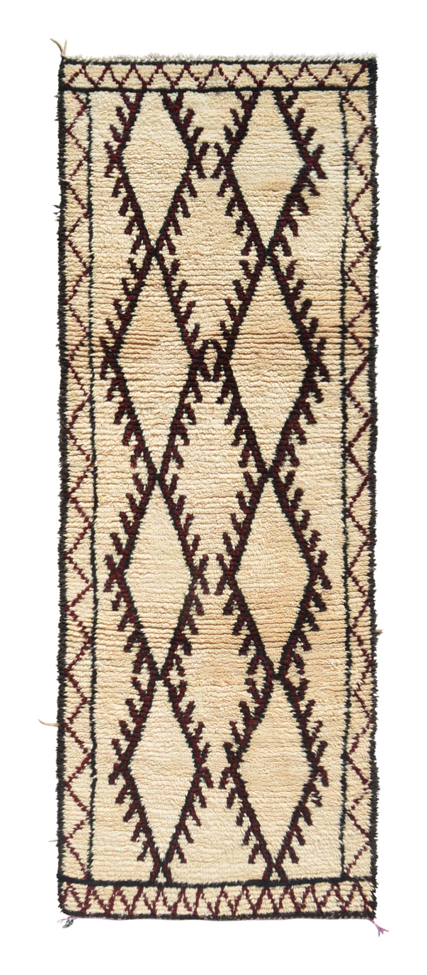 Overhead view of a deeply plush, highly structured handmade 1960s vintage Beni Ourain Moroccan wool and cotton runner rug named Riptide (3'5" x 9'7") featuring a cream base framed by a dark border, with three large, connected central diamonds displaying toothed, comb-like jagged edges woven in rare, deep ox blood red yarn, with a 3/4-inch pile.