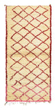 Overhead view of a very soft, deeply plush handmade 1970s vintage Beni Ourain Moroccan wool and cotton runner rug named Love You (3'4" x 7'10") featuring a thick cream base with a minimalist geometric diamond lattice that transitions beautifully from deep red to bright pink, with a 1-inch pile.